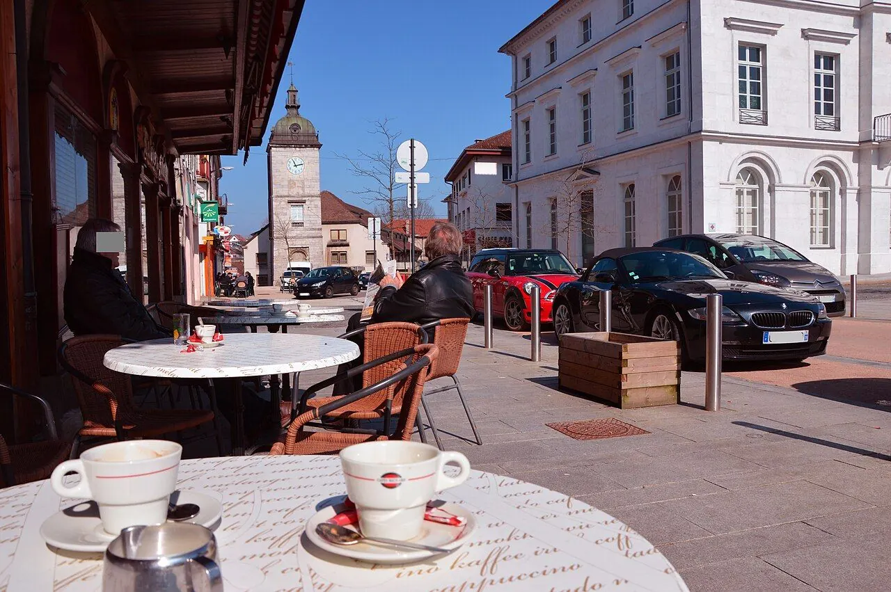 Champagnole downtown, Jura , Franche-Comté . Café in the Avenue de la République. In the background the water tower .