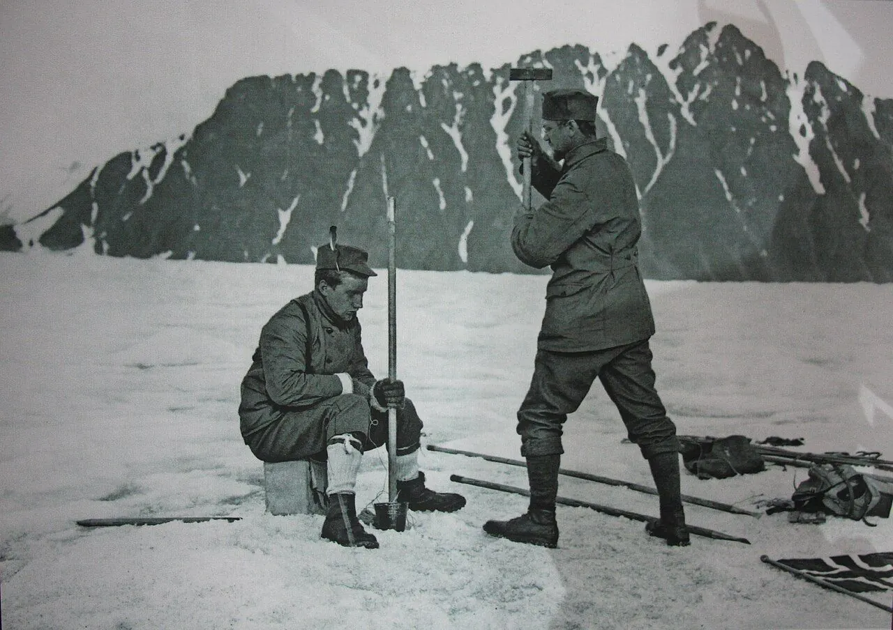 Norwegian explorer Adolf Hoel (right) raising tent at Lilliehöök Glacier in Kings Bay, Svalbard. Photo by Norwegian Institute for Svalbard and Ice Sea Exploration (NSIU), 1907. Property Rights expired