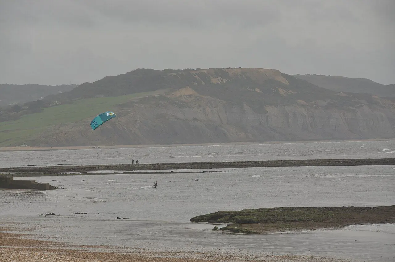 Kitesurfing lesson on a sandy beach with instructor