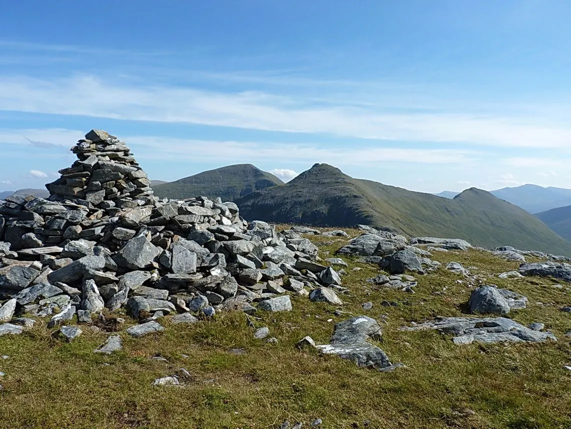 Hillwalker on a rocky Scottish mountain summit ridge