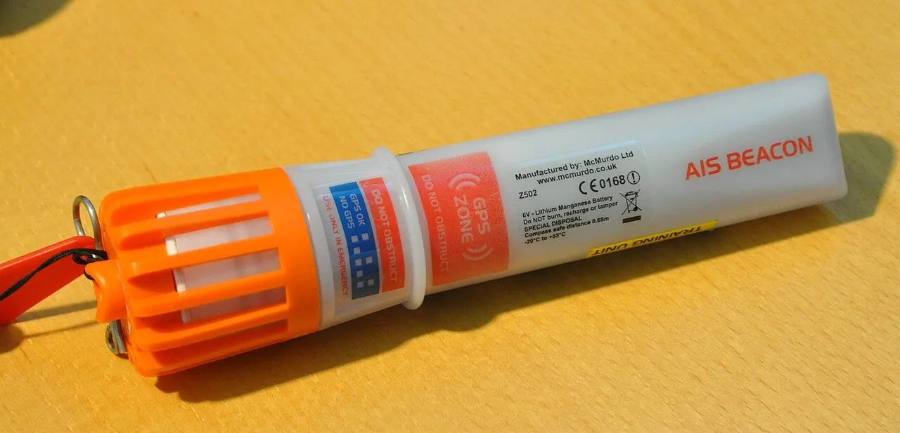 Personal locator beacon clipped to a rucksack strap