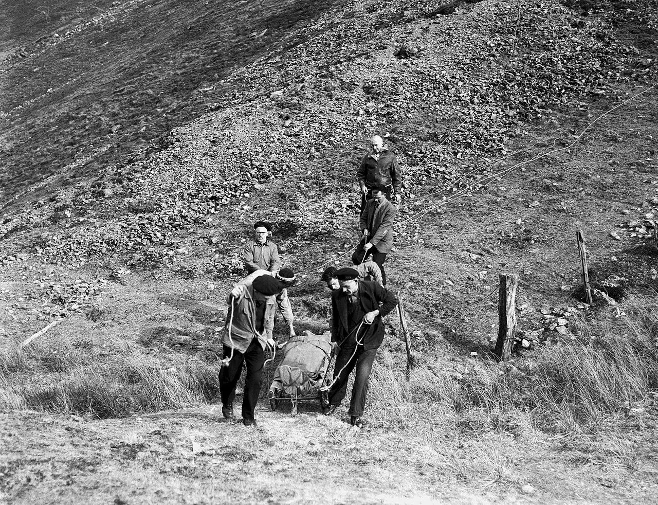 Rescuers wrapping a cold walker in a blanket